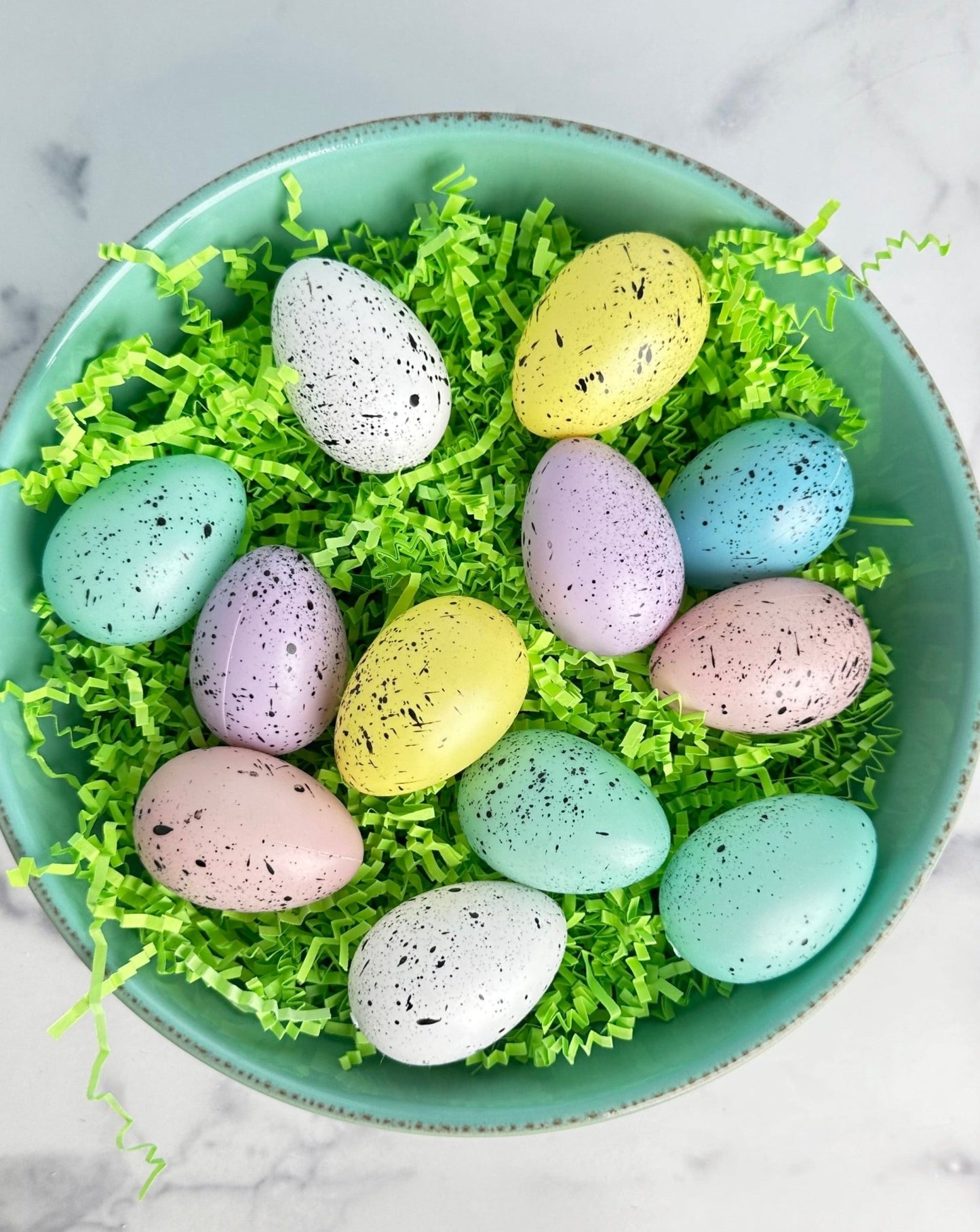 set of 12 speckled faux easter eggs in a green organza bag
