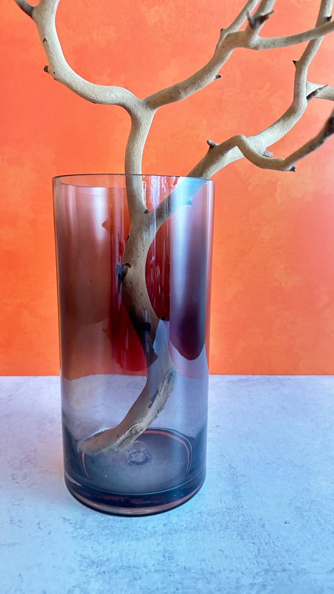 our beautiful smoked glass vase is perfect for Halloween or any time of year this large clear glass vase has an elegant grey smoked finish size is approx. 10" tall by 5" wide