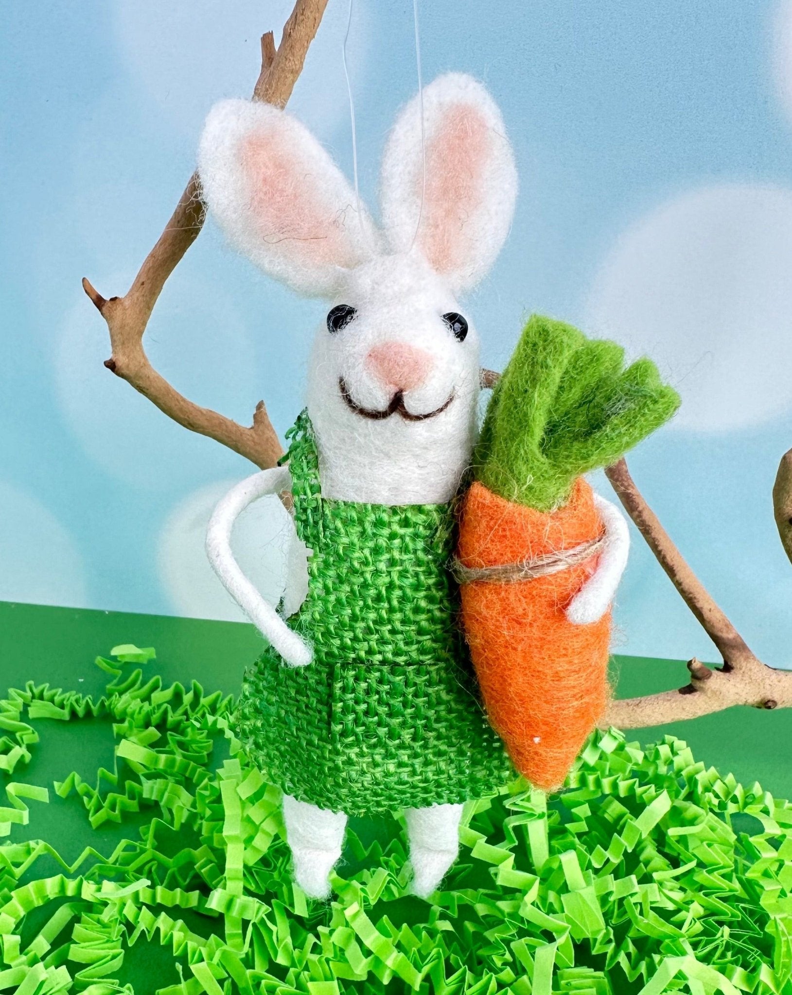 Beatrice the garden bunny is here to brighten you day. With her bright green outfit and big floppy ears, she holds a giant carrot in her hand.