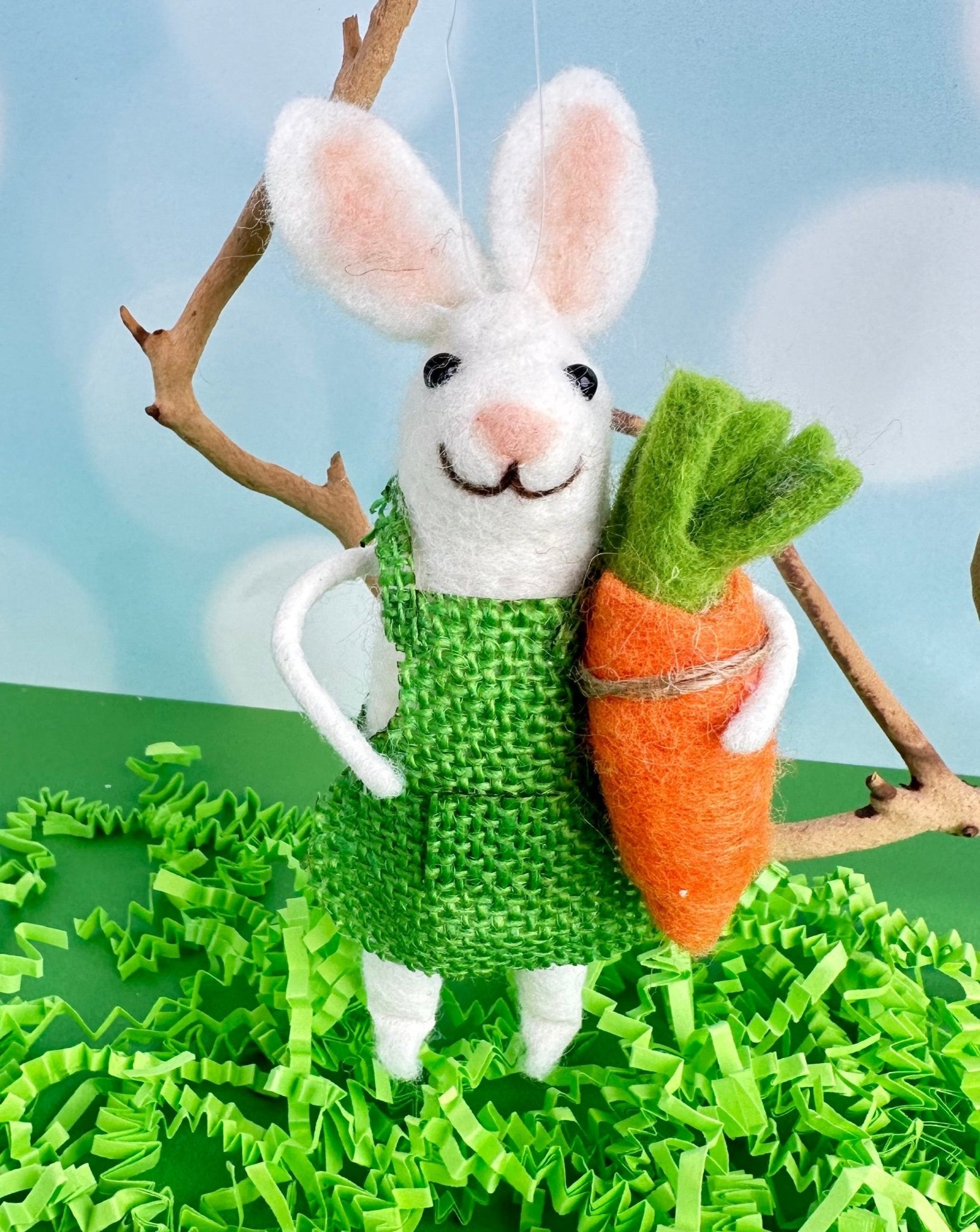 Beatrice the garden bunny is here to brighten you day. With her bright green outfit and big floppy ears, she holds a giant carrot in her hand.