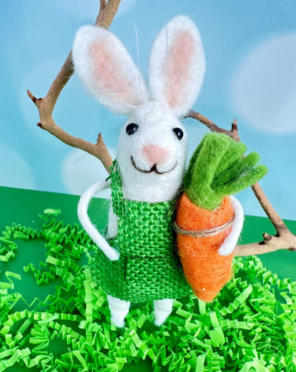 Beatrice the garden bunny is here to brighten you day. With her bright green outfit and big floppy ears, she holds a giant carrot in her hand.