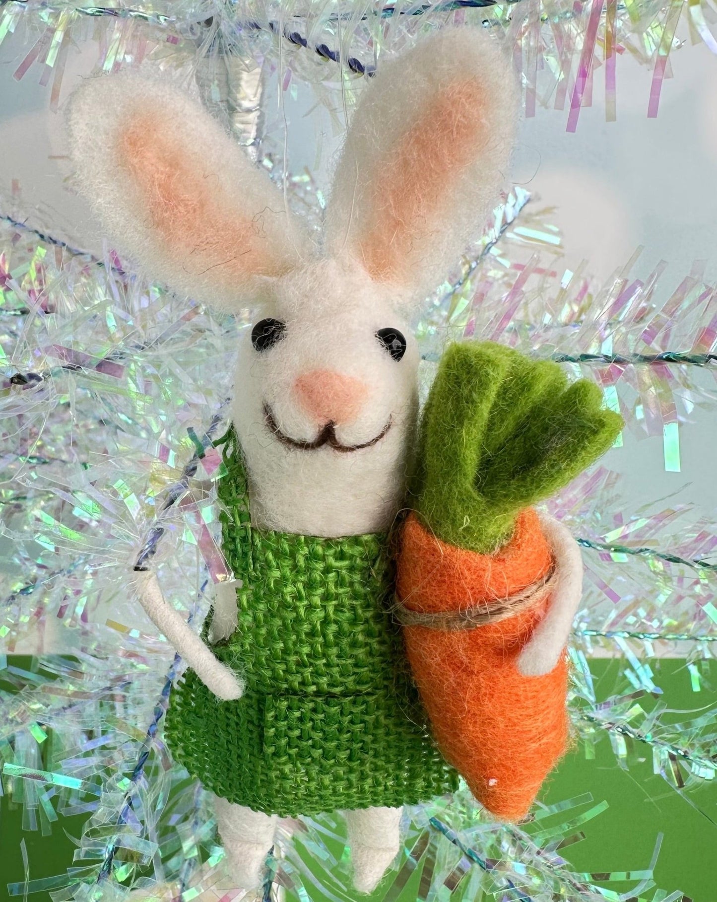 Beatrice the garden bunny is here to brighten you day. With her bright green outfit and big floppy ears, she holds a giant carrot in her hand.