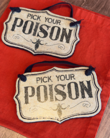 This set of two Halloween ornaments features two decorative hanging signs that reads 'PICK YOUR POISON' in distressed black lettering on an off-white background, suspended by a black ribbon.