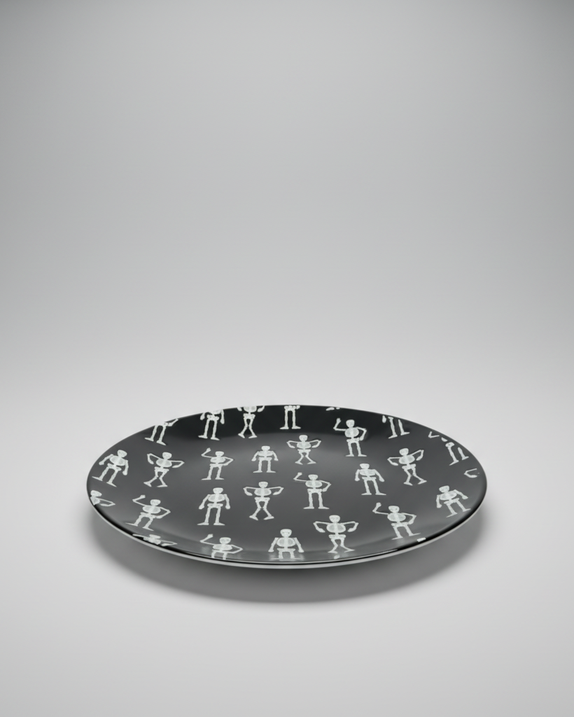 This quirky, fun Halloween Salad Plate is a round black ceramic plate with a repeating white pattern of small dancing skeletons. Approx. 8.5" round.