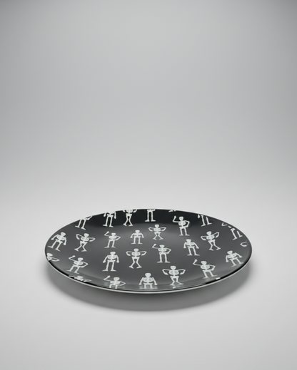 This quirky, fun Halloween Salad Plate is a round black ceramic plate with a repeating white pattern of small dancing skeletons. Approx. 8.5" round.