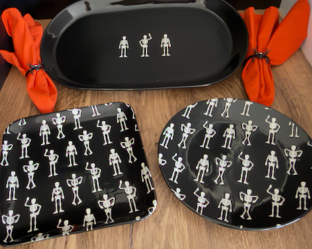 This quirky, fun Halloween Salad Plate is a round black ceramic plate with a repeating white pattern of small dancing skeletons. Approx. 8.5" round.