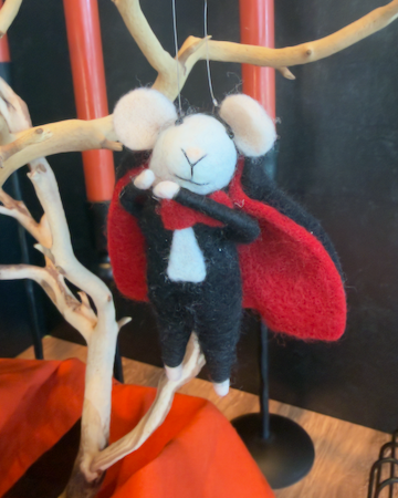 A felted wool vampire mouse hanging from a branch, wearing a black suit, white collar, and red cape. Approx 6" tall.