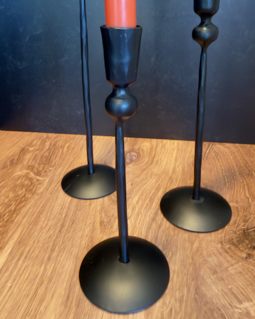 Our Witch's Coven Taper Holders. This set of 3 tall, slender black metal candle holders look like they are hand forged from steel. These spooky holders create a dramatic gothic display that feels right at home in a witch’s cottage, haunted manor, or Halloween tablescape.