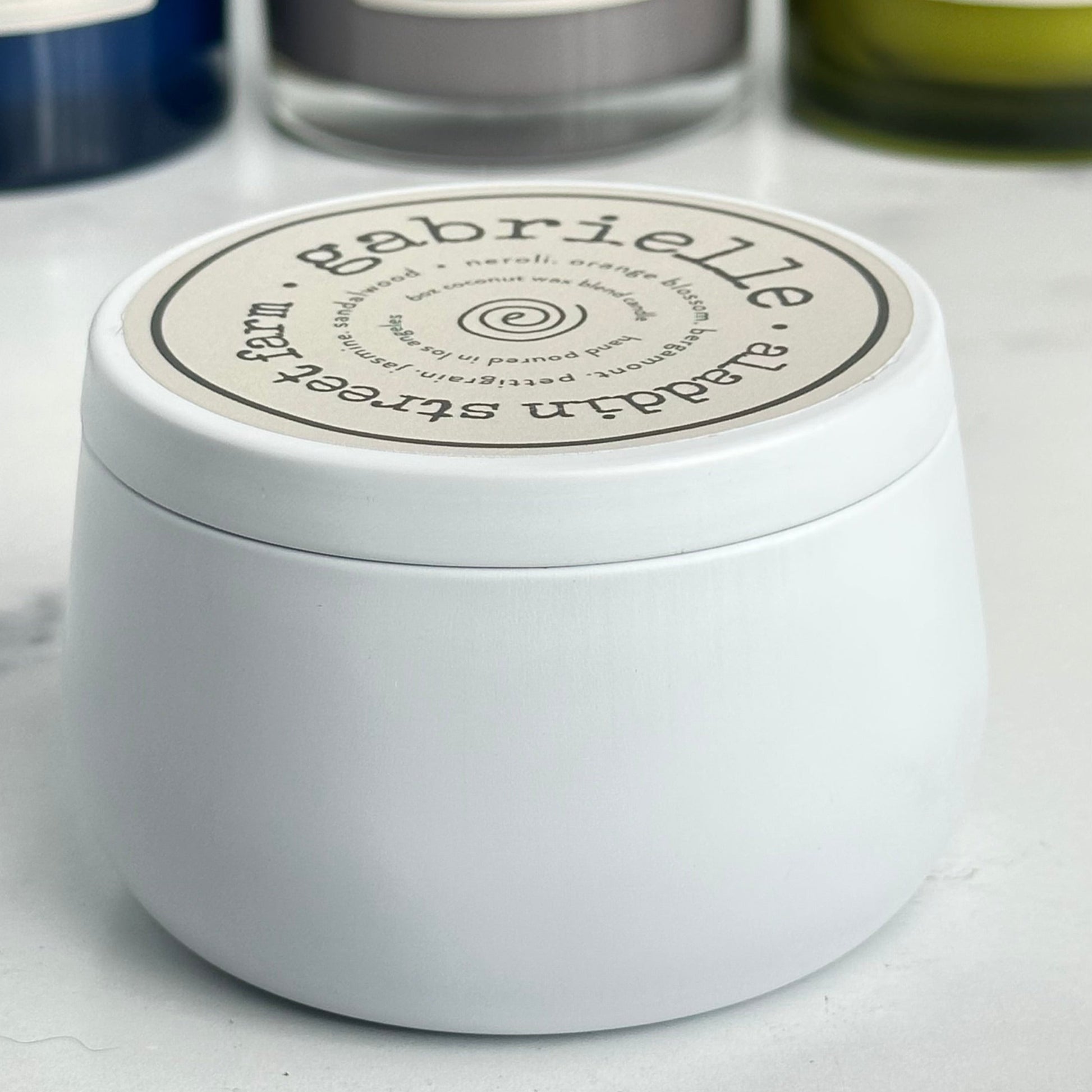 a side view of the gabrielle candle tin